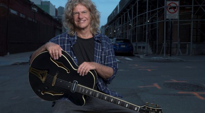 pat metheny holding guitar