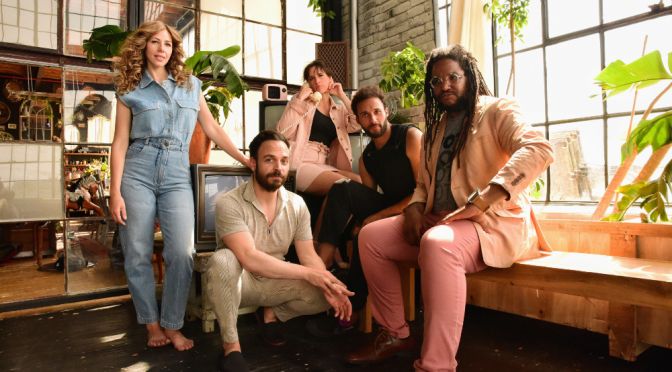 lake street dive five people posing for photo one standing three sitting one squatting